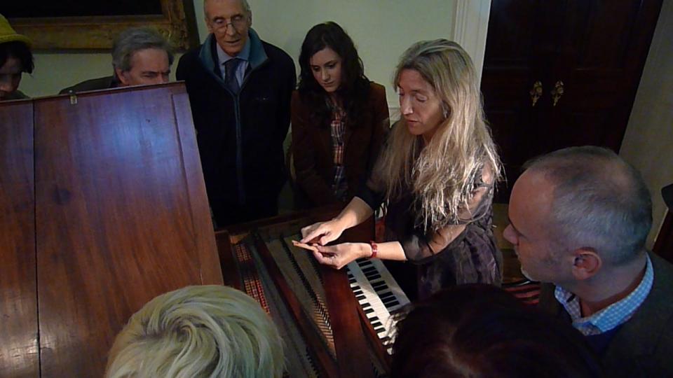 Jane Chapman shows the harpsichord at Tatton Park to onlookers