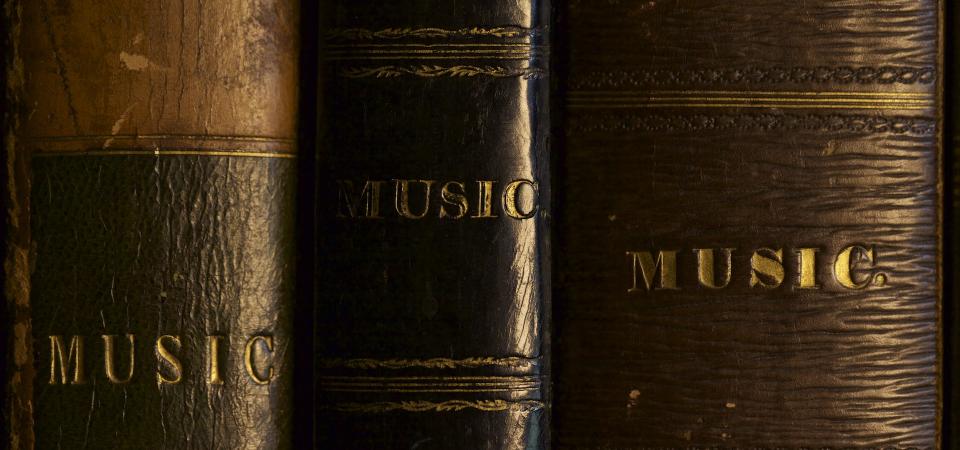 Three music books at Tatton Park showing "MUSIC" on their spines, photographed by Aura Satz